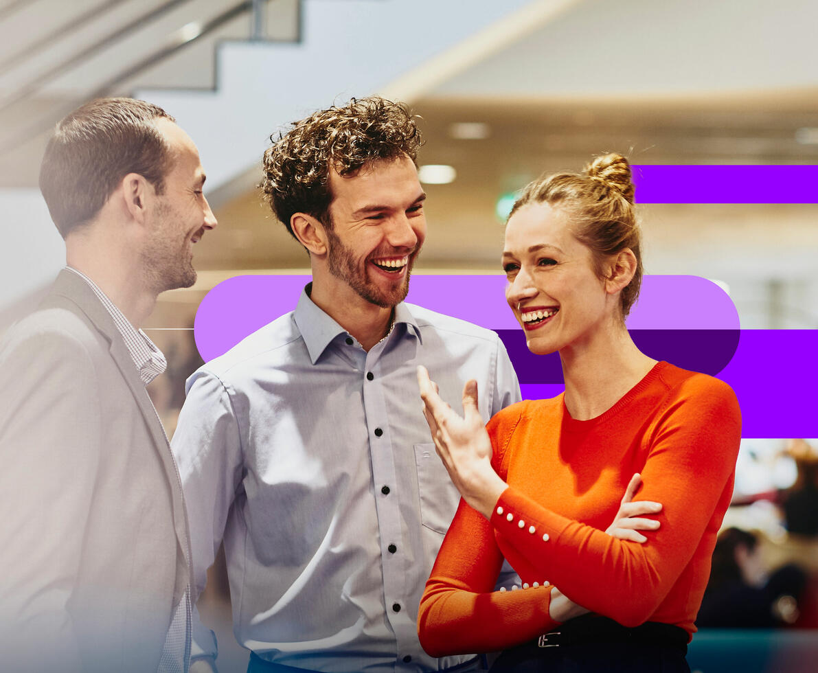 an image of coworkers talking and smiling 
