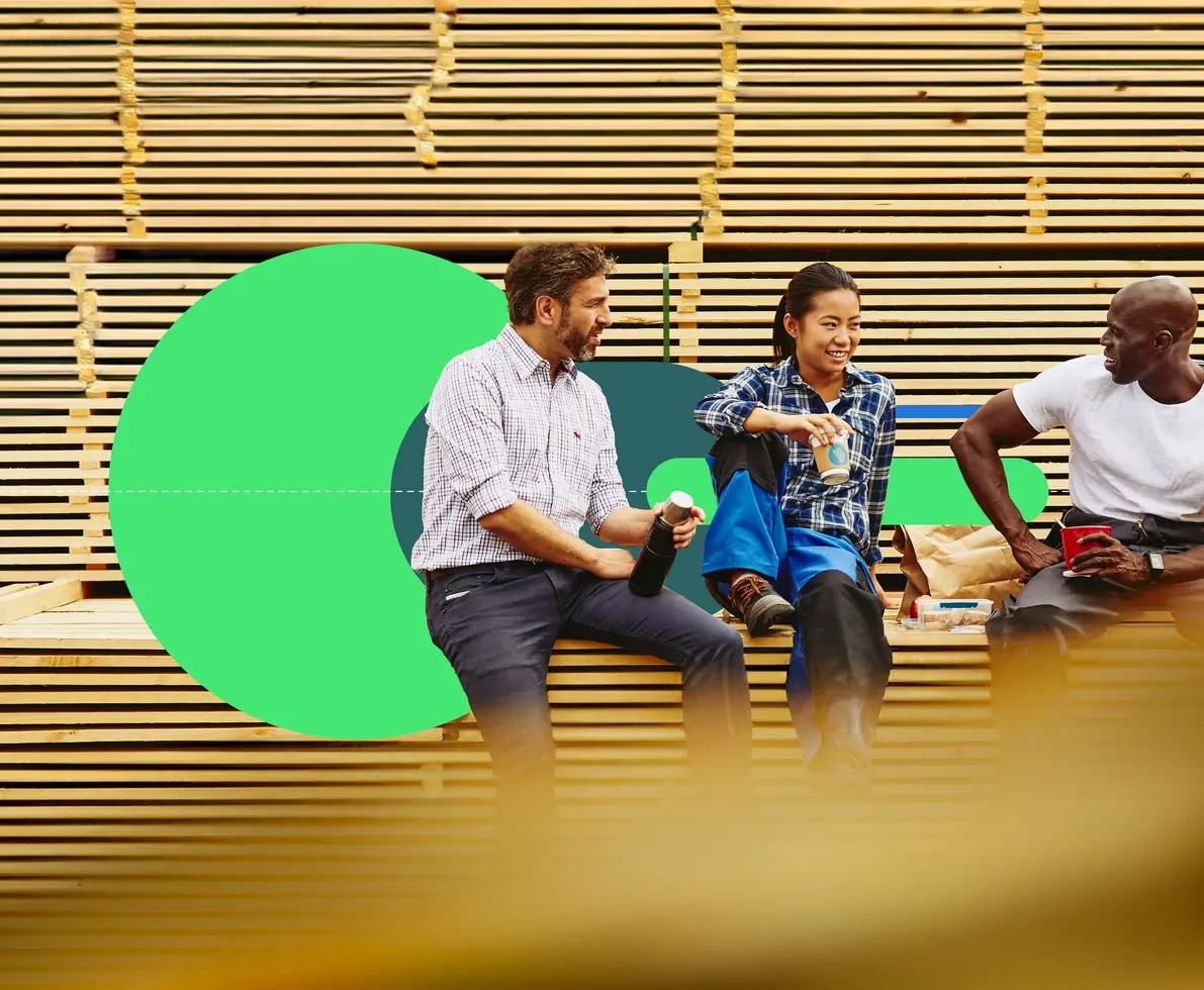 an image of three colleagues chatting and smiling while taking a break from work