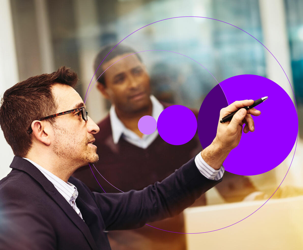 an image of two men working together in an office