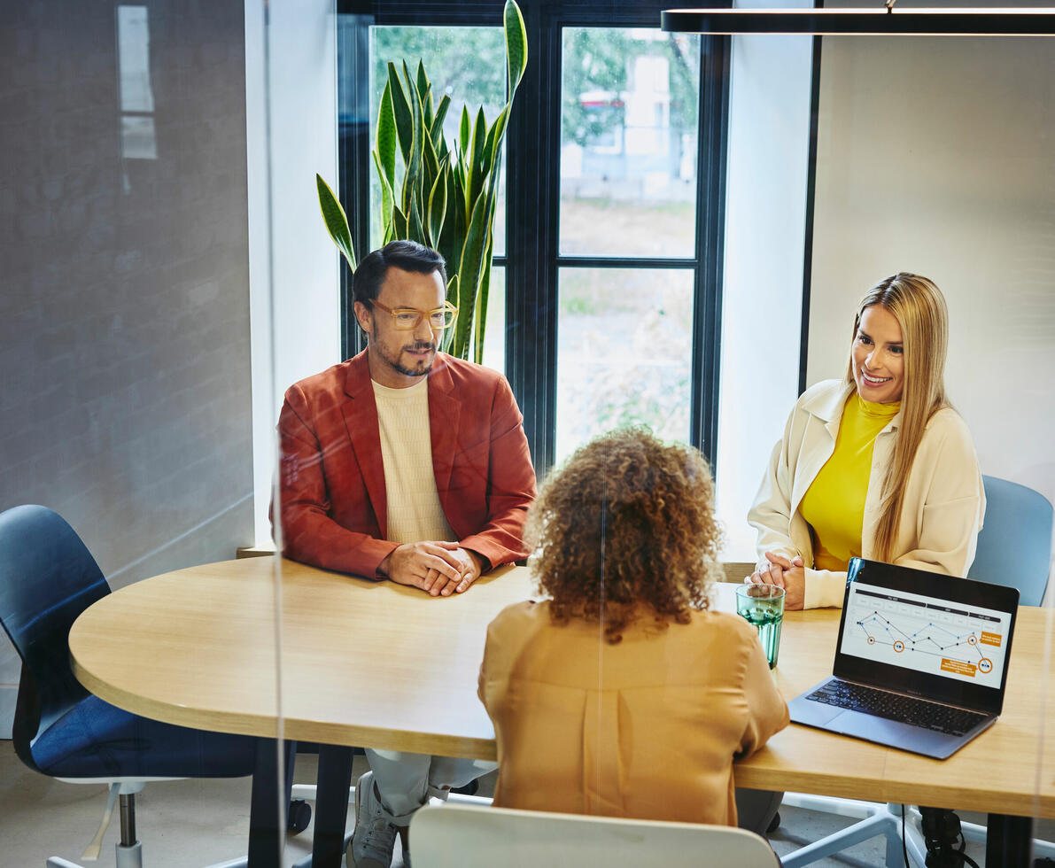 Three colleagues in conversation