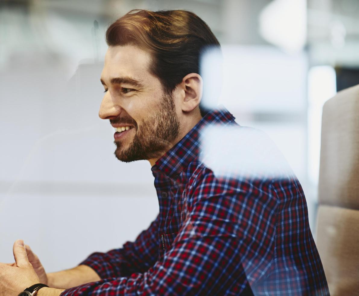 Man with beard in an office. 