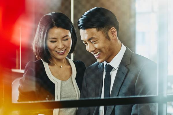 A photo of a man and woman working as system accountants