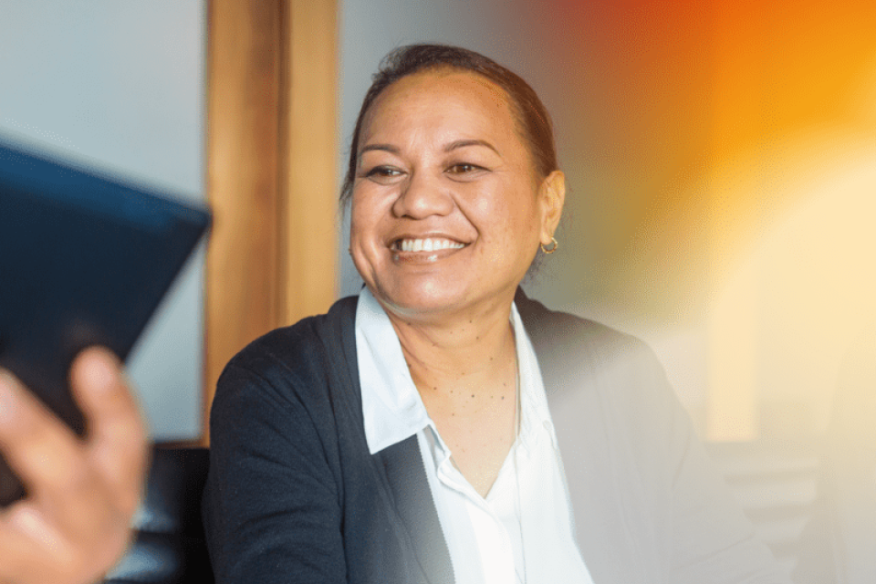 A photo of a woman smiling while being interviewed 