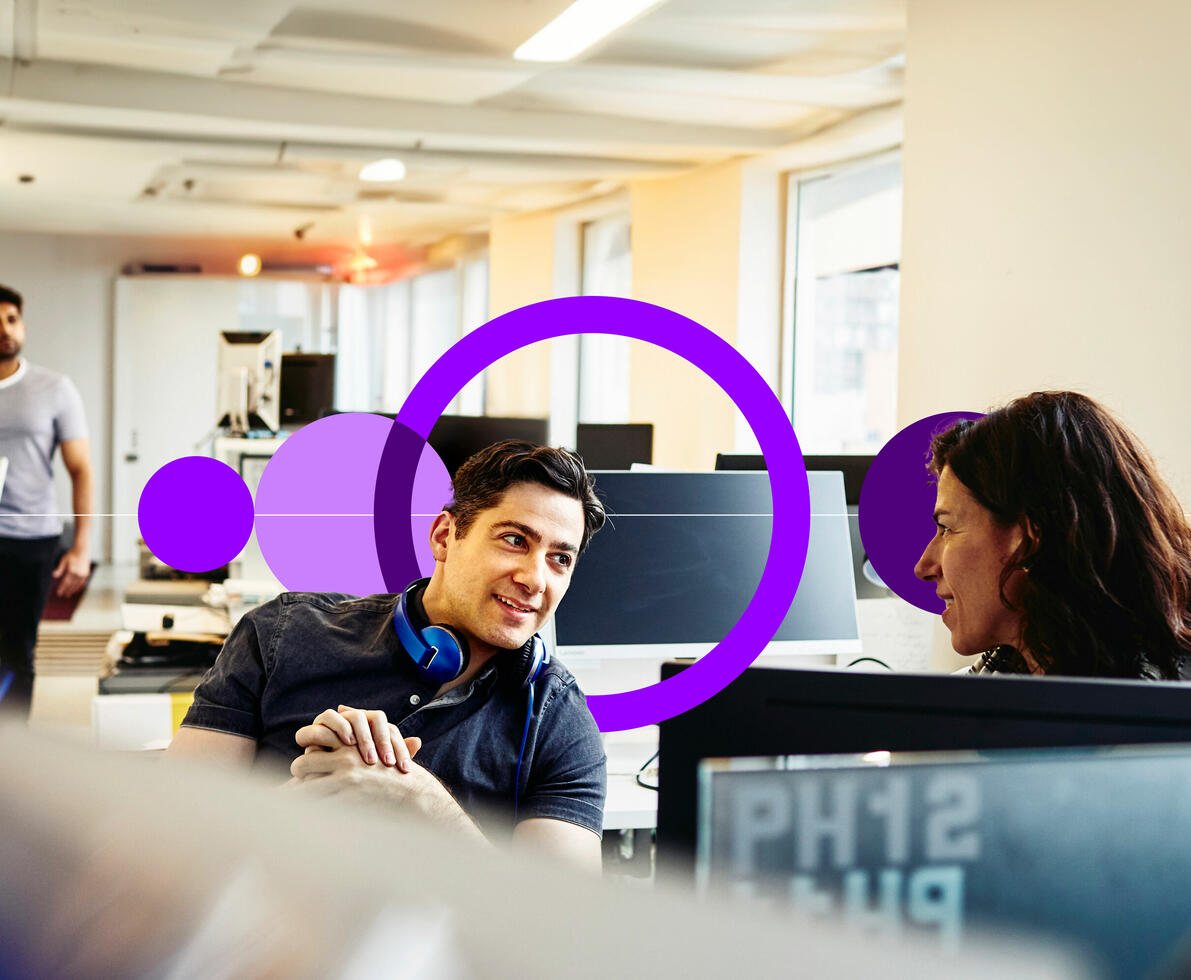 an image of two coworkers talking in their workspaces an image of two coworkers talking in their workspaces